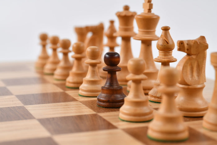 Handcrafted marble chess set with black and white pieces on a luxury board