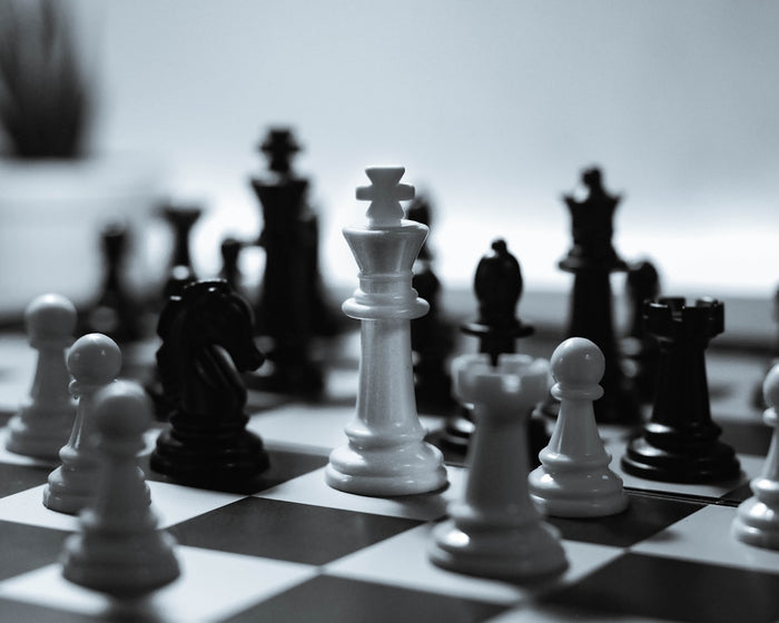 Classic board games chess checkers and peg solitaire set up on a table