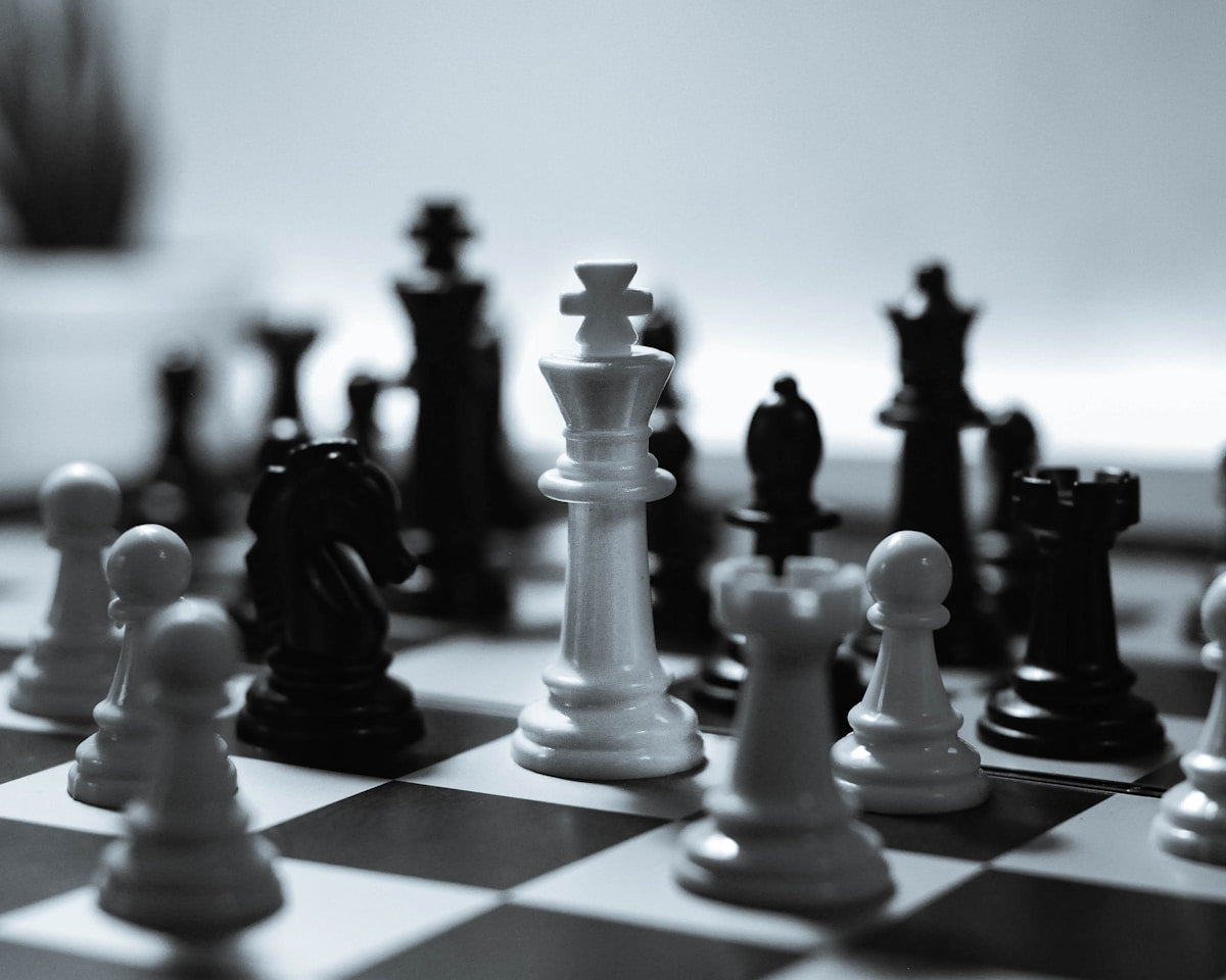 Classic board games chess checkers and peg solitaire set up on a table